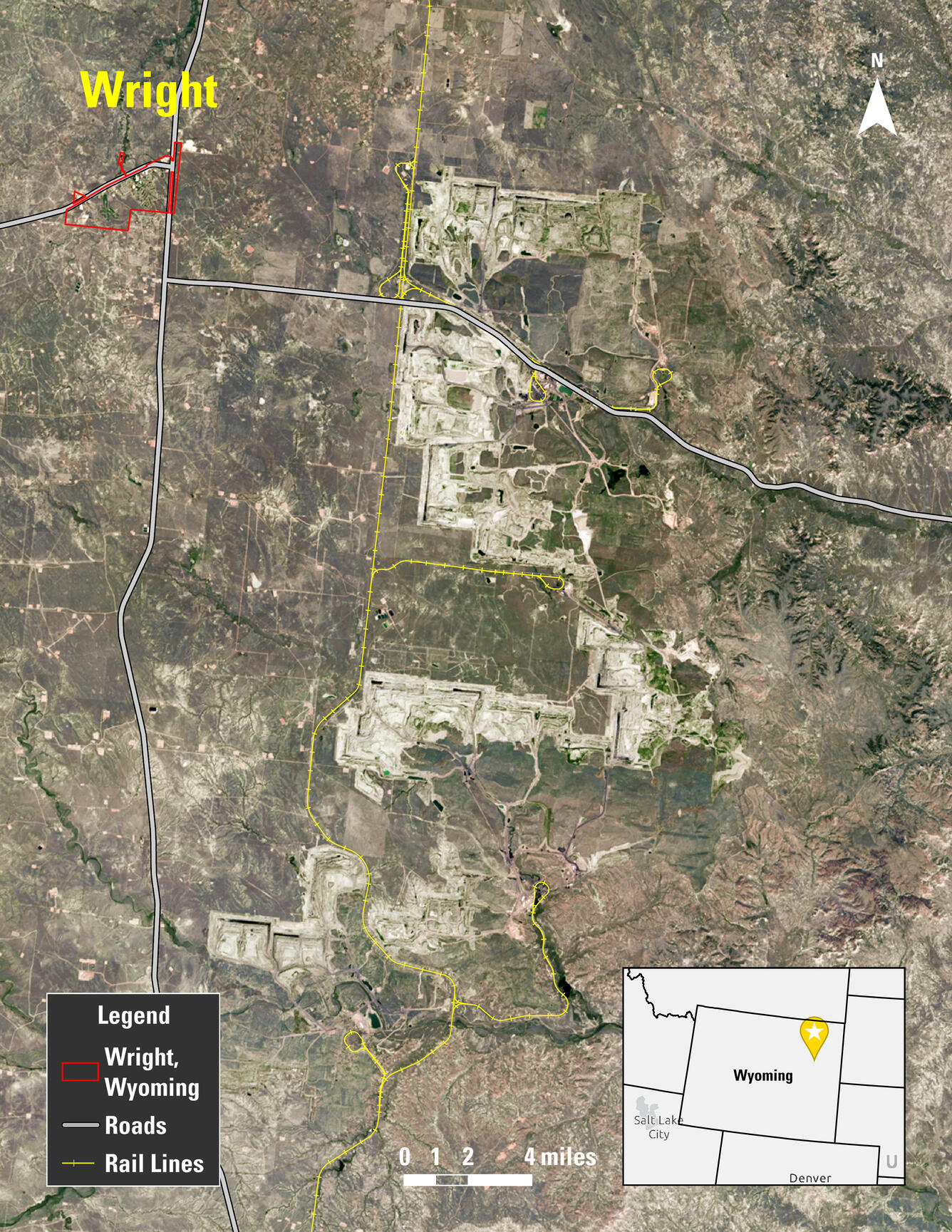 Map of an area with railroad tracks and roads indicated, along with a town and grassland areas