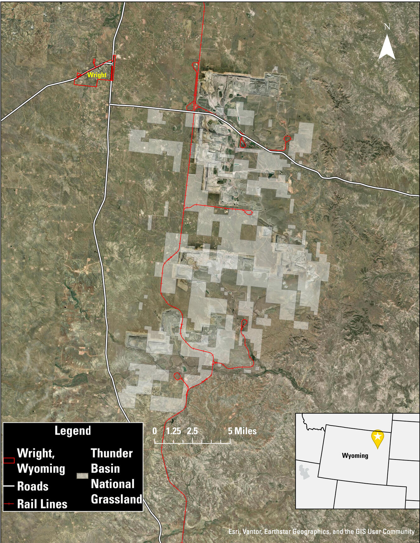 Map of an area with railroad tracks and roads indicated, along with a town and grassland areas