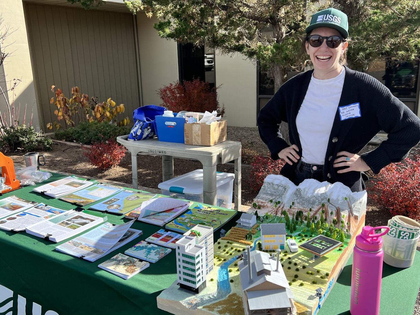 Kat Cooney stands in front of an outreach table on the Flagstaff USGS campus