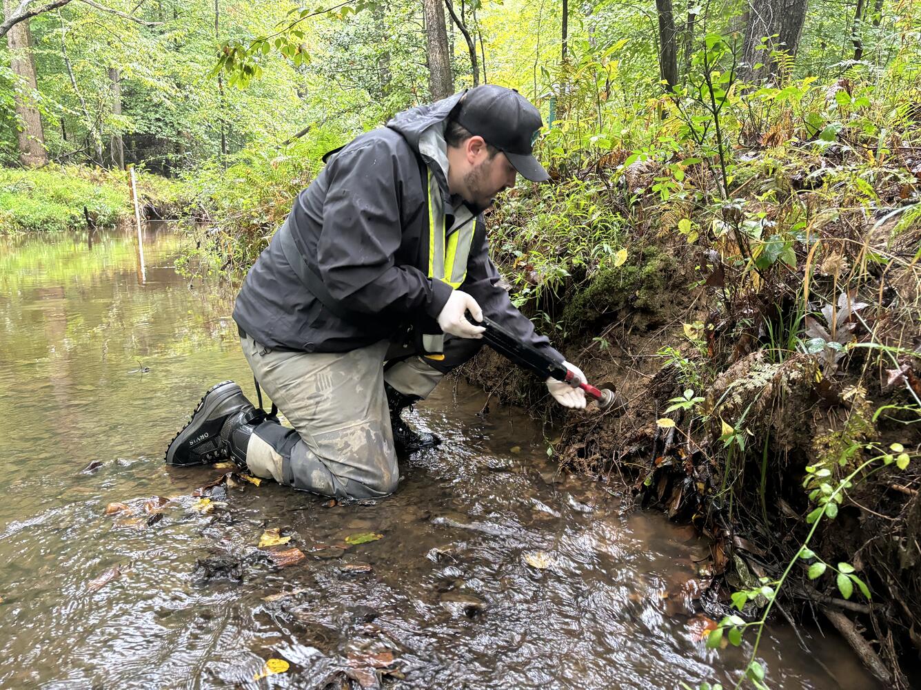 a USGS scientist collects a soil sample