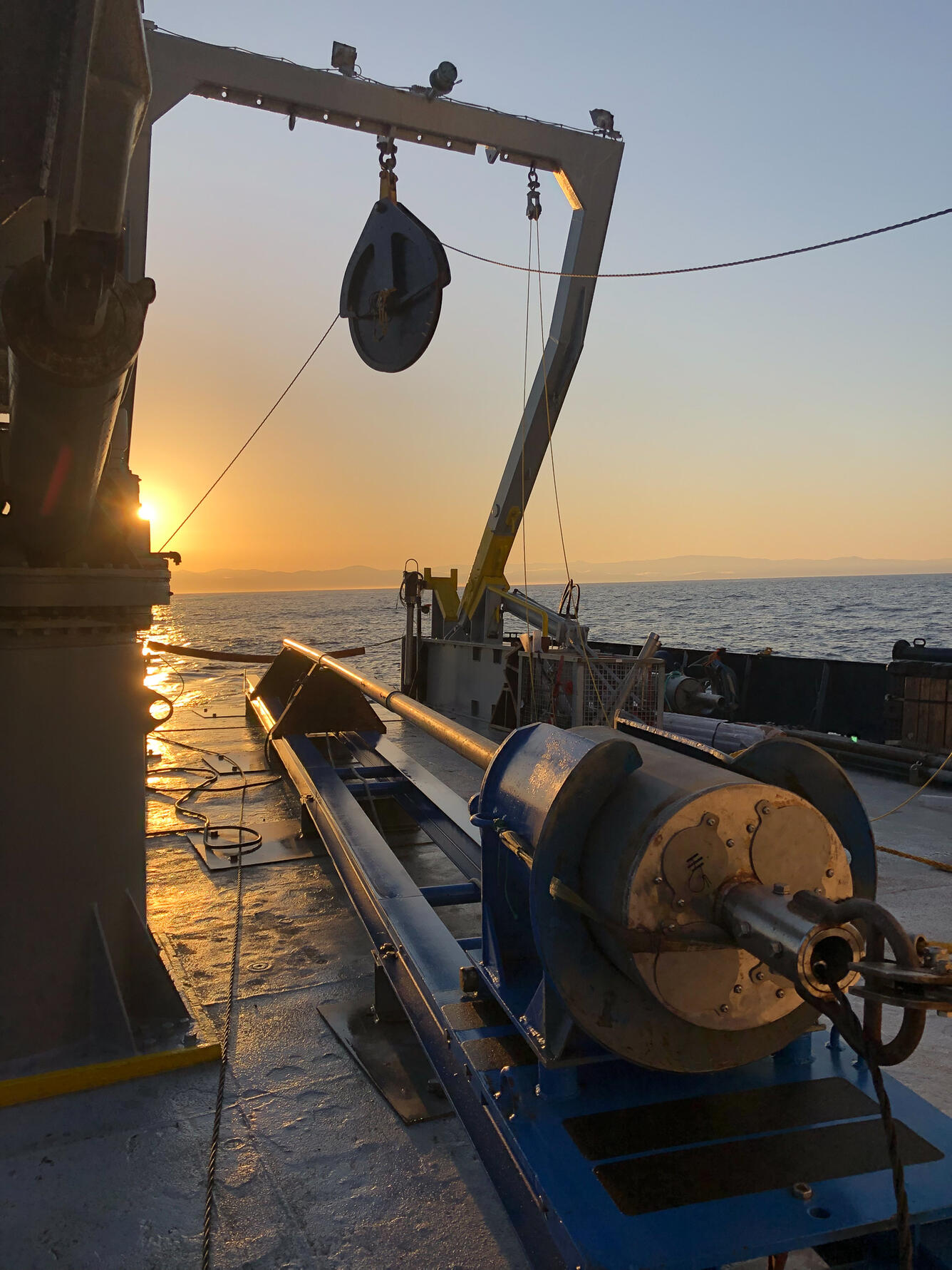 Sunset with the jumbo piston core on its track system on the aft deck