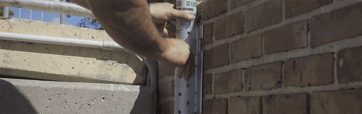 A visualization of a storm-tide sensor and receiving bracket being installed