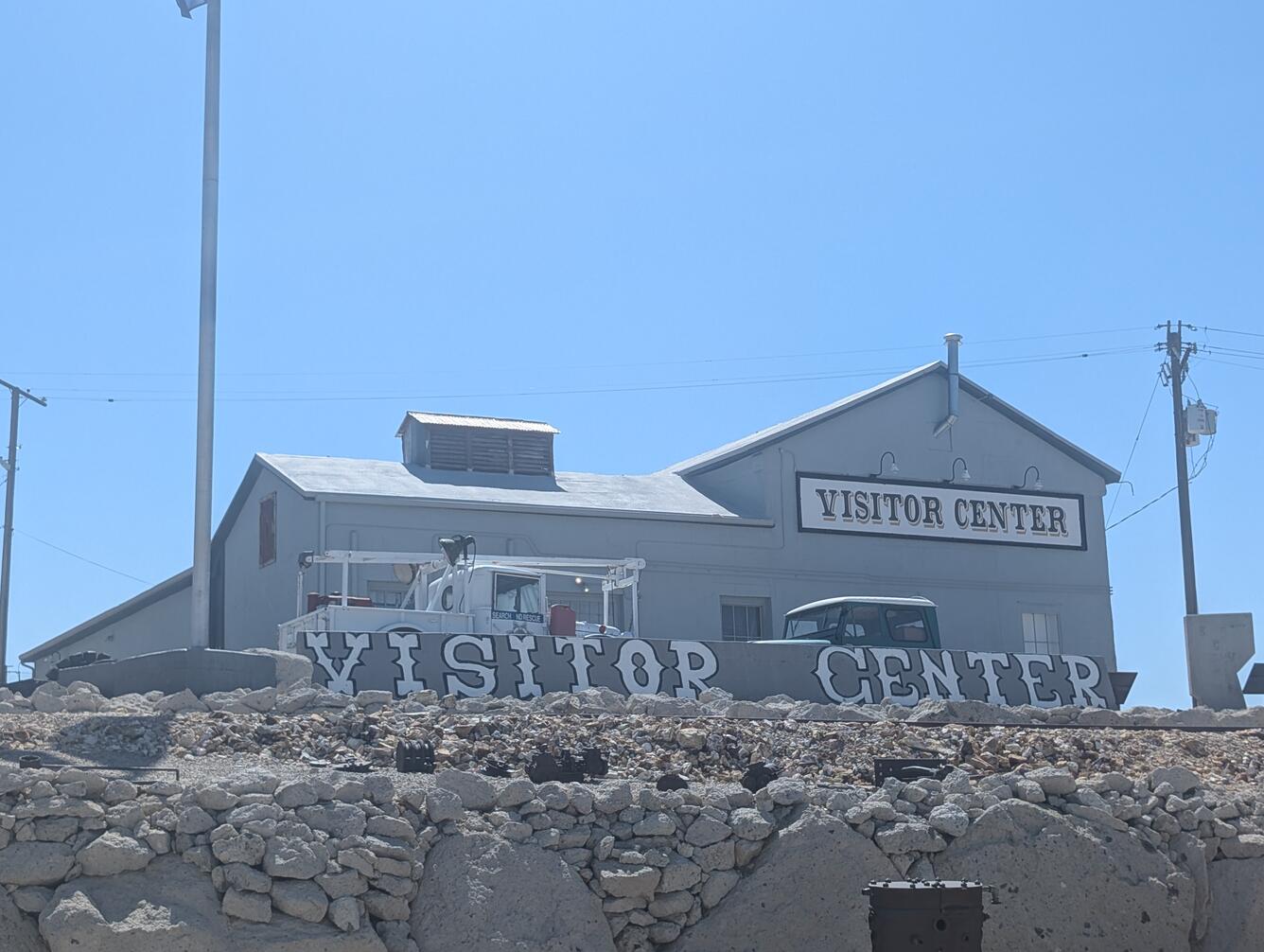 Photo of the Tonopah Historic Mining Park Visitor Center; gray building against bright blue sky.