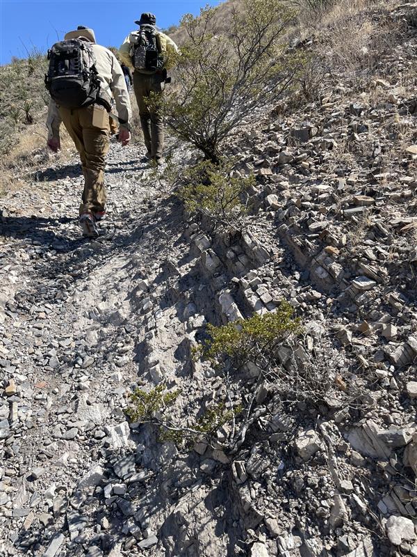 Geologists on a West Texas Geological Society site visit to the Woodford Shale, visible underfoot and to the right of photo.