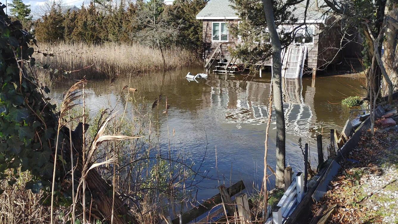 Flooded front yard of a house near the Wading River.