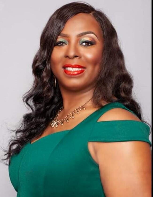 woman wearing green dress smiling at camera