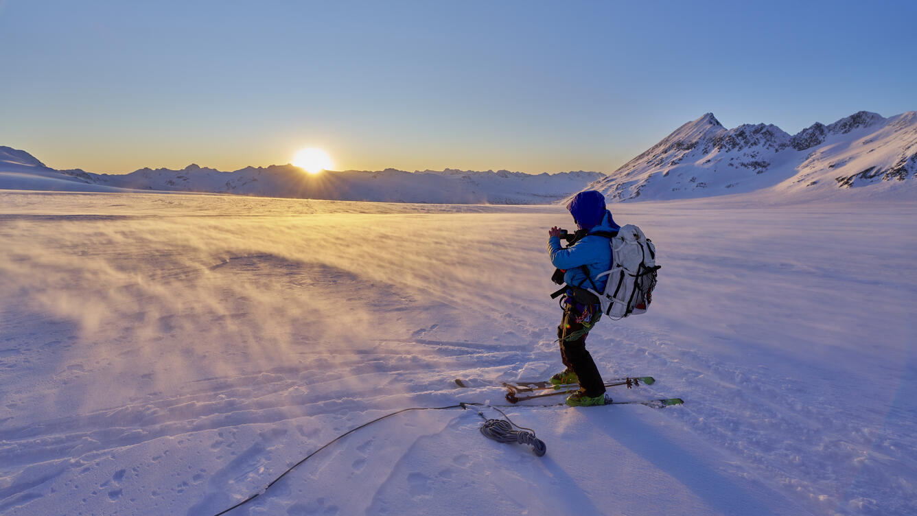Person on skis standing on a glacier.