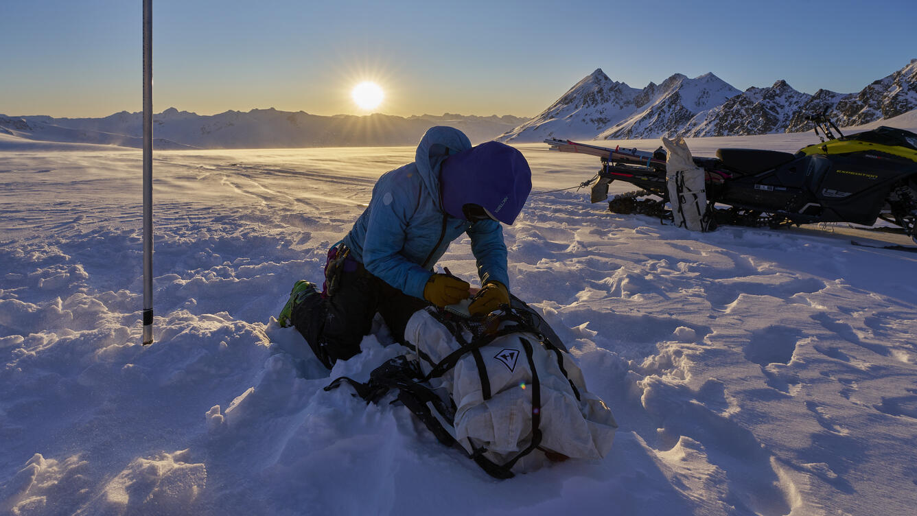 Person taking notes while on a glacier.