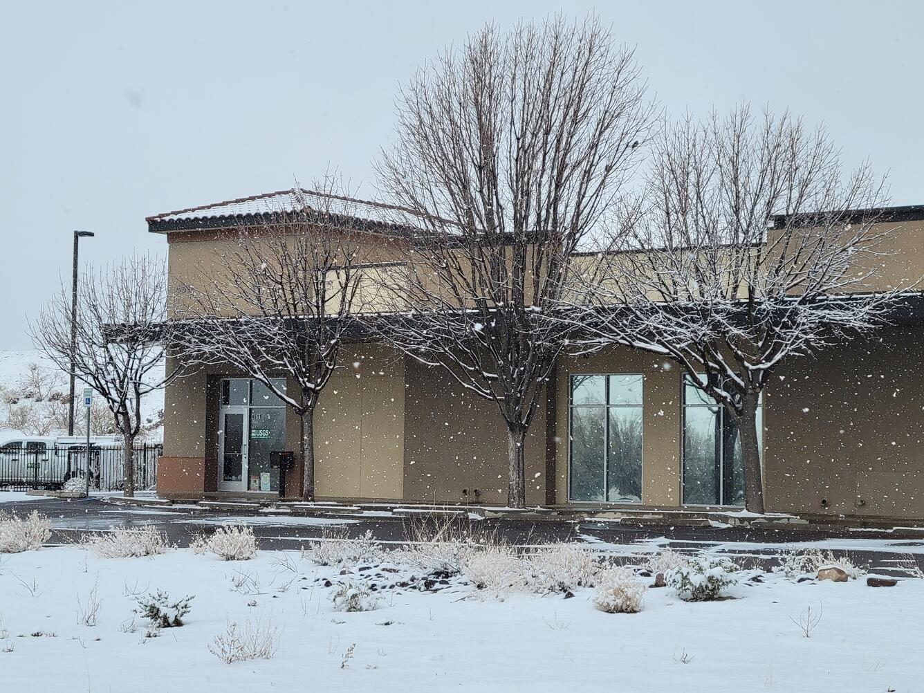 A snow-covered building during a light winter storm