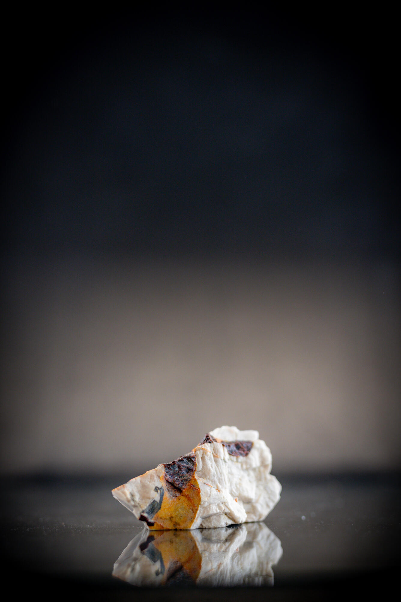 Isolated USGS mineral specimen featuring almandite garnet and calcite.