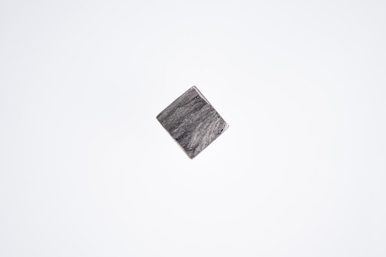High-definition image of an isolated aluminum specimen with smooth surface and subtle oxidation.