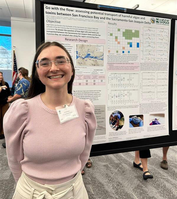 Physica Scientist, Amelia Ayers stands in front of her poster illustrating the transport of harmful algae in the Delta.