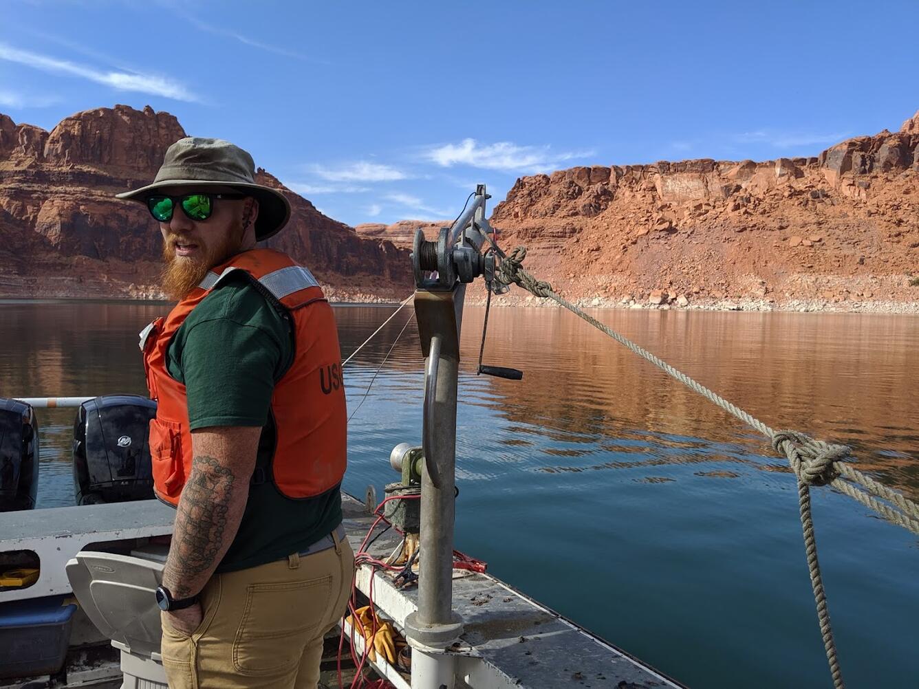 Hydrotech, Andrew Karlson, operates boat and sediment sample crane on Lake Powell