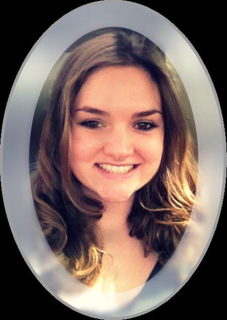 A profile picture of a woman with brown, shoulder length hair smiling at the camera.