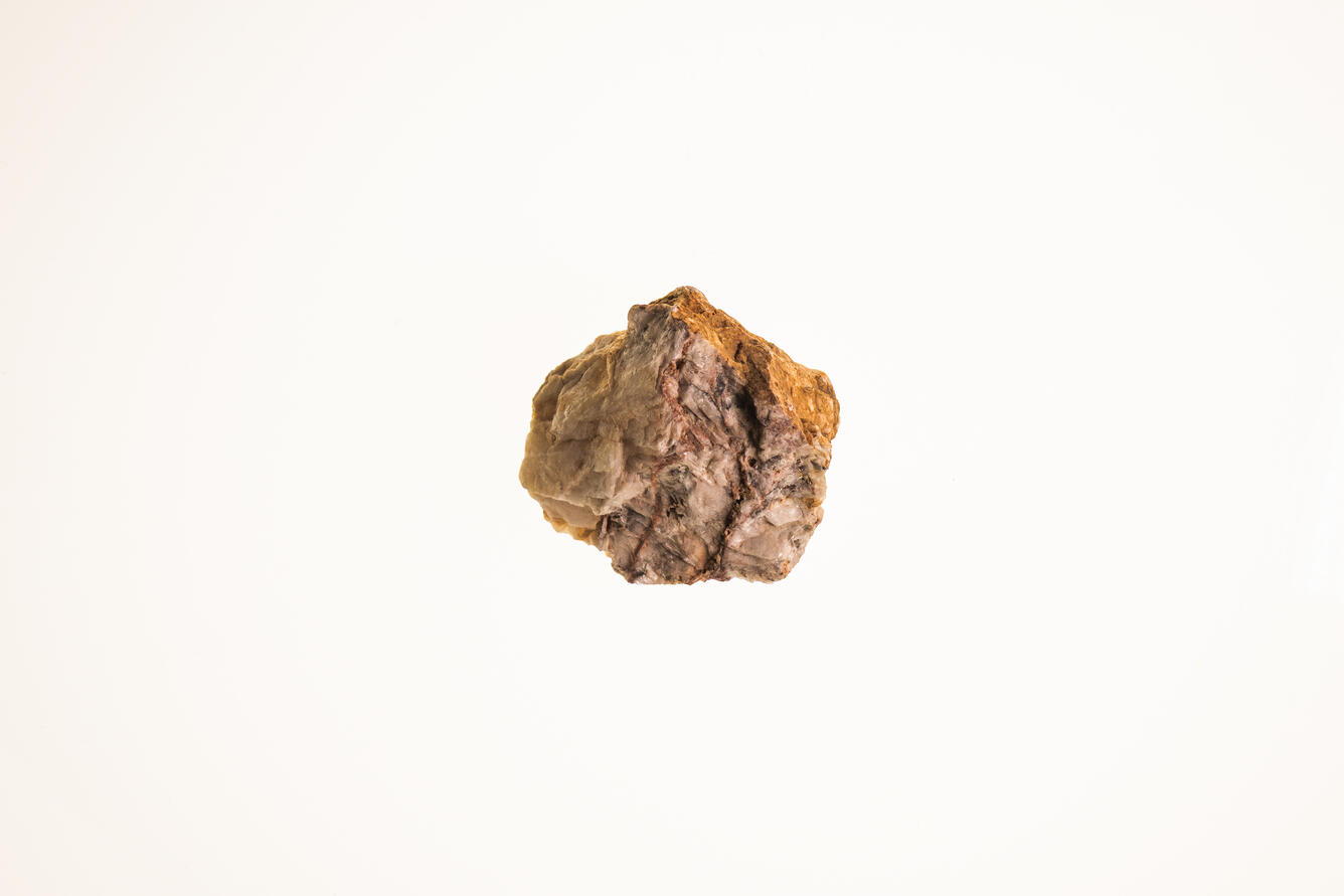 Isolated USGS mineral specimen of barite with visible crystal faces and granular texture.