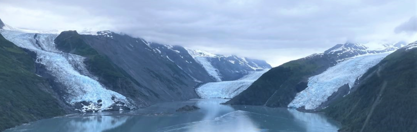 mountains with 3 glaciers surrounding an ocean inlet