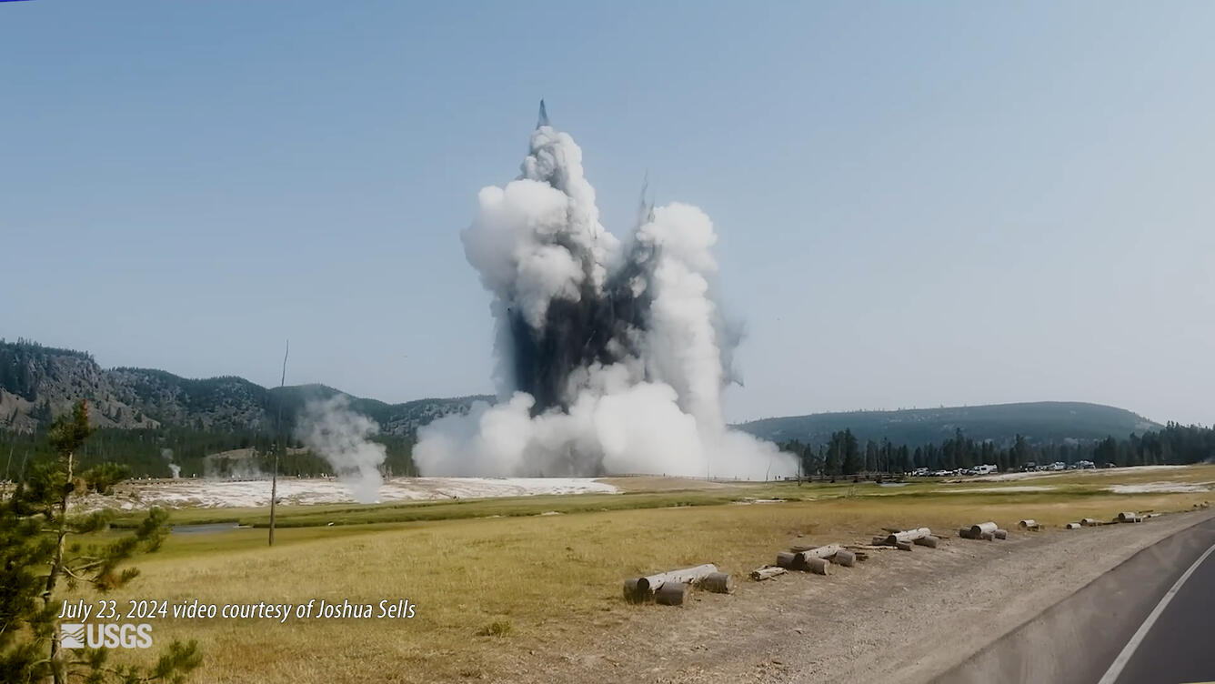 Large cloud of smoke and rock rising from the air.