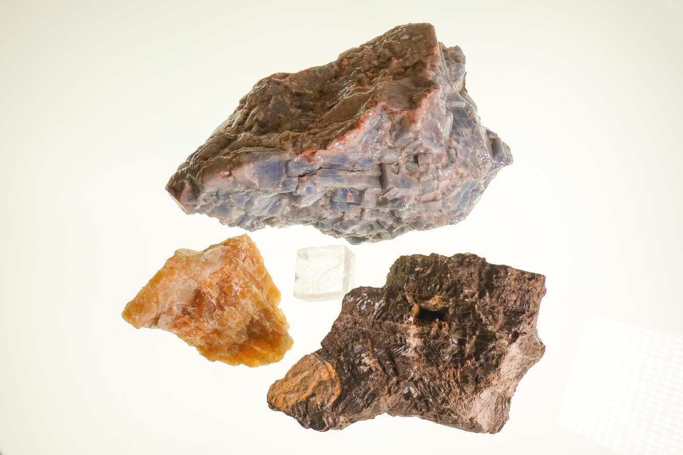 High-definition image of multiple calcite specimens showing diverse crystal structures and color variations.