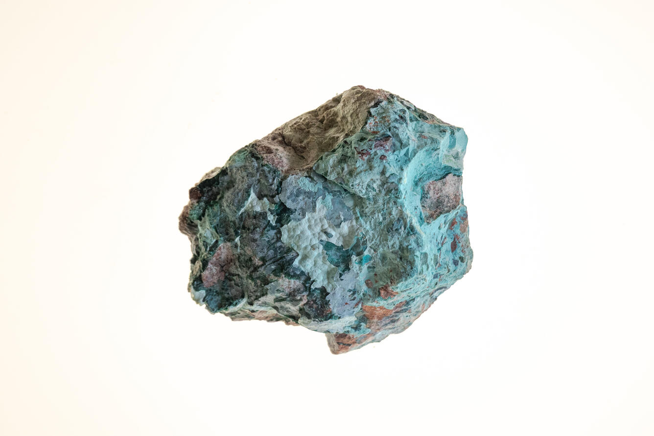 High-definition image of chrysocolla specimen with rough texture and turquoise coloration.