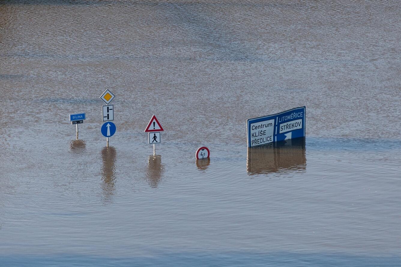 Street signs in floodwaters