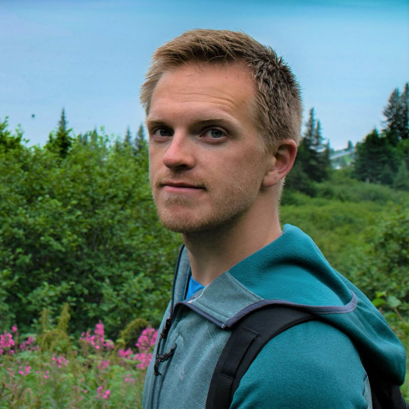 person with trees and plants in background