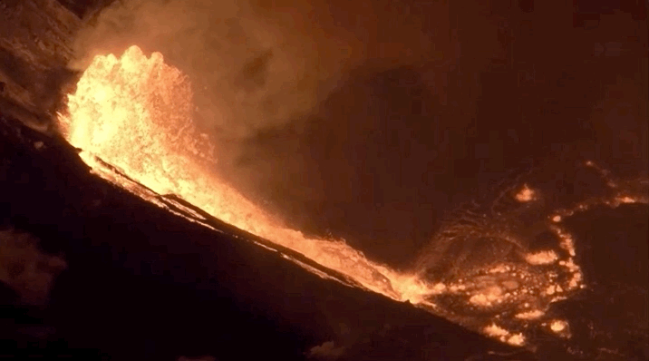 Animation showing bright orange lava erupting at night and flowing into a pool of lava.