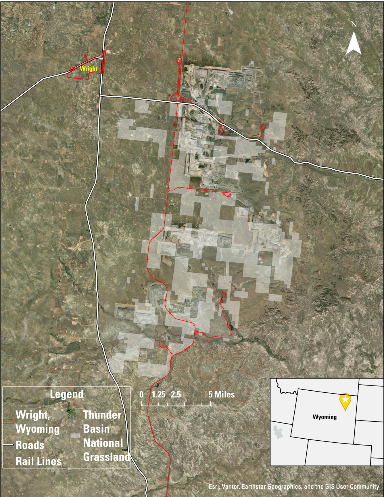 Map of an area with railroad tracks and roads indicated, along with a town and grassland areas