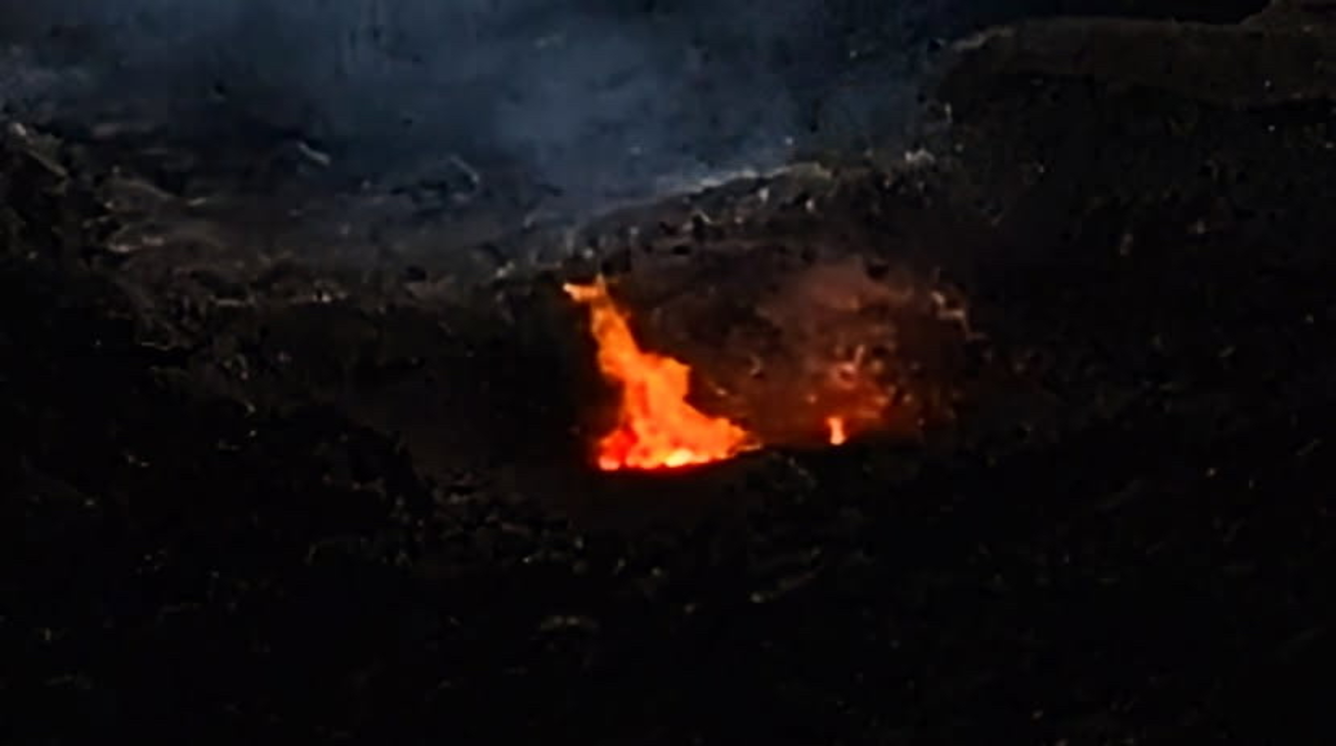 Color photograph of flames within a volcanic vent