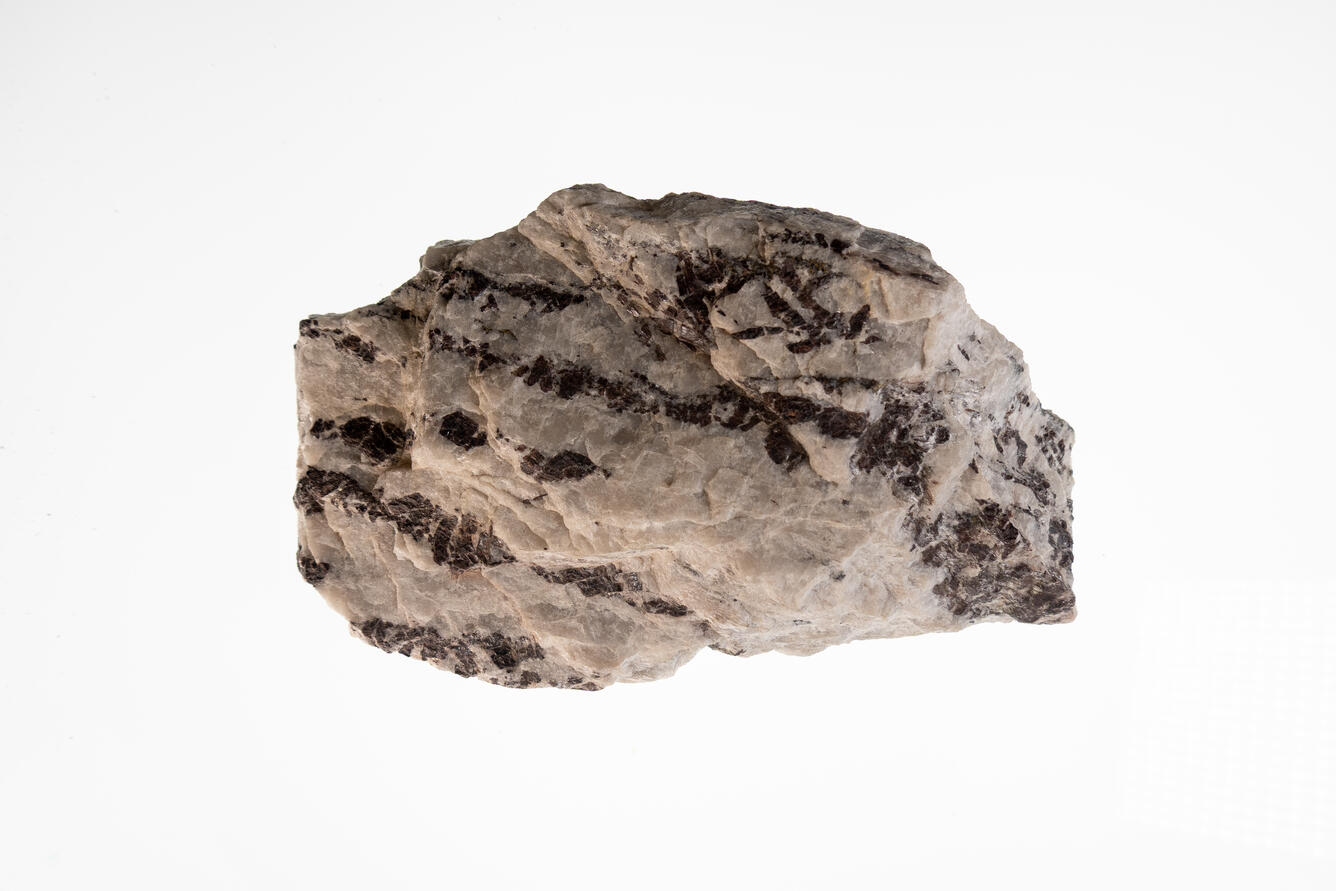 Graphite in Pegmatite, USGS mineral specimen of graphite crystals in pegmatite rock.