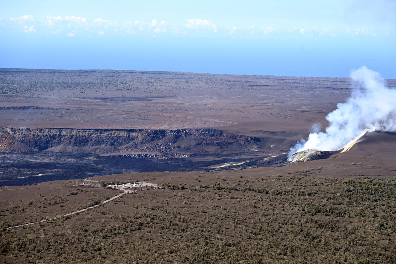 Color photograph of degassing volcanic vents within crater