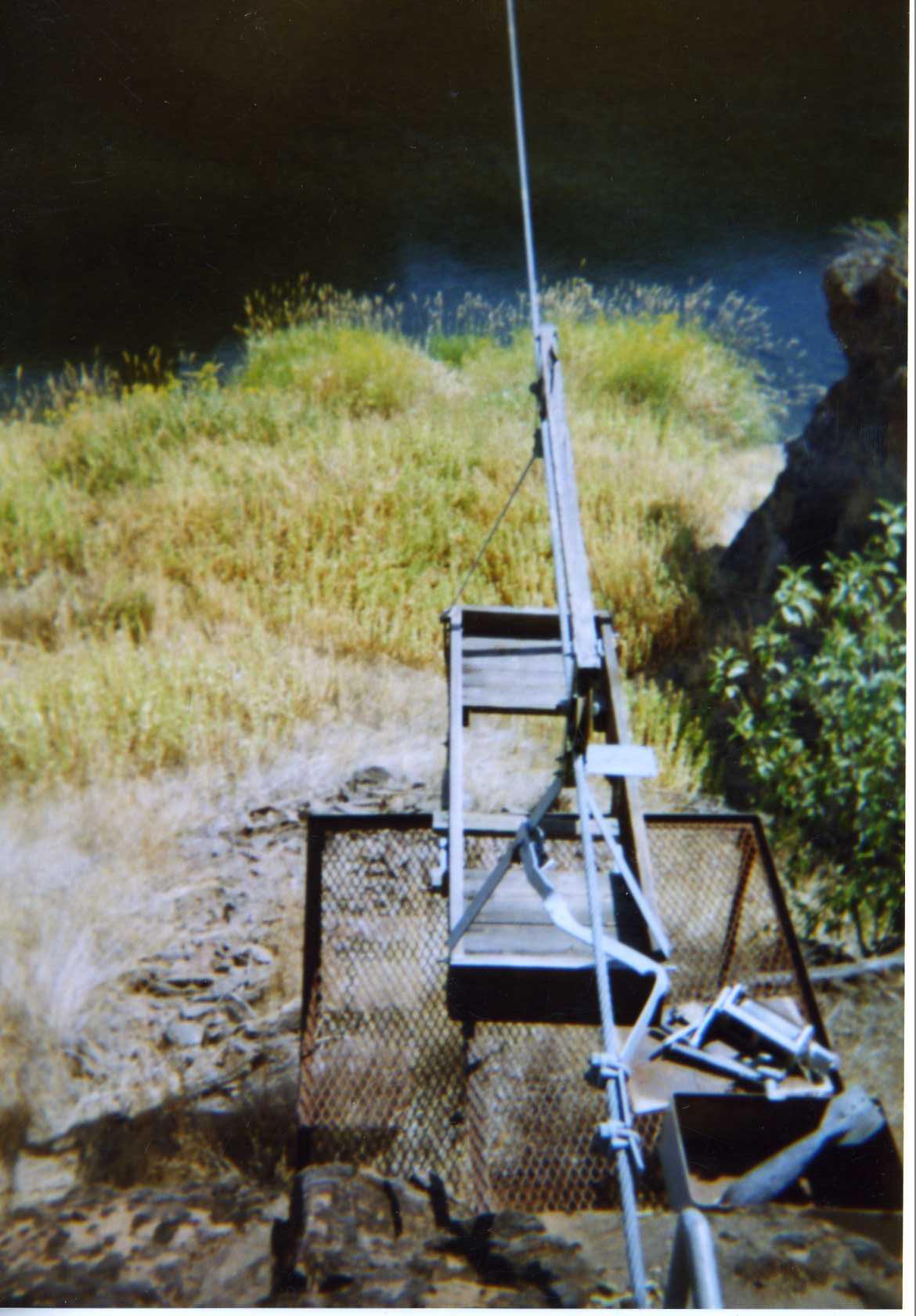 Wooden seat on cable spanning river
