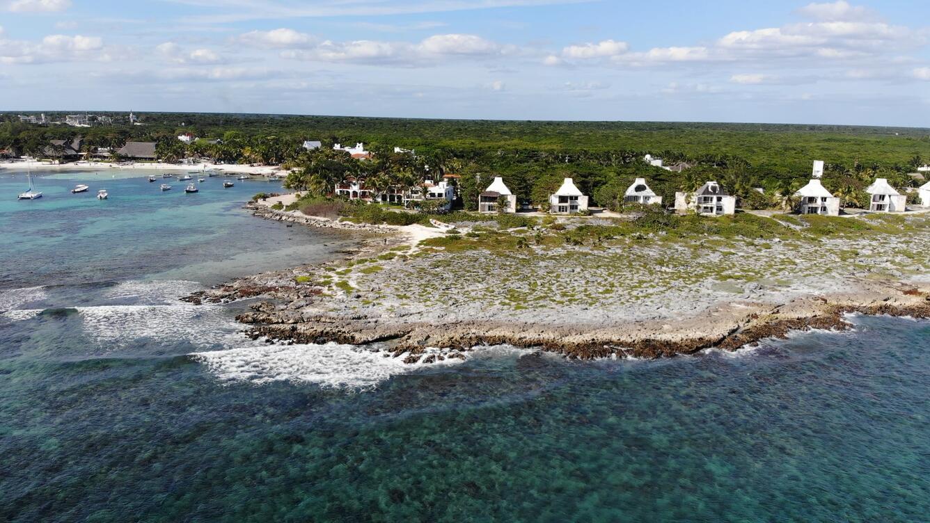 Aerial view of coastline, water, and sky