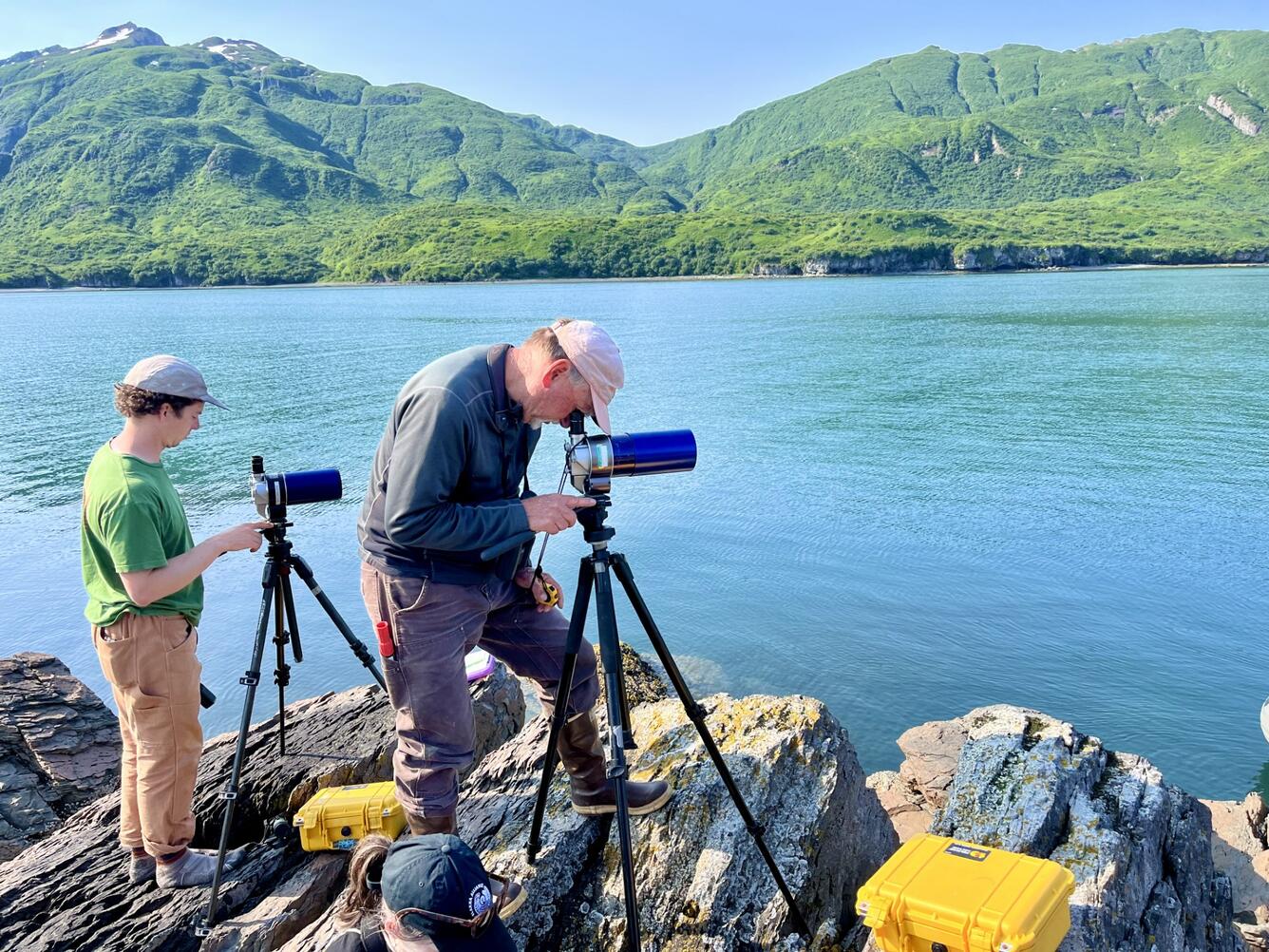 Two people looking through telescopes.