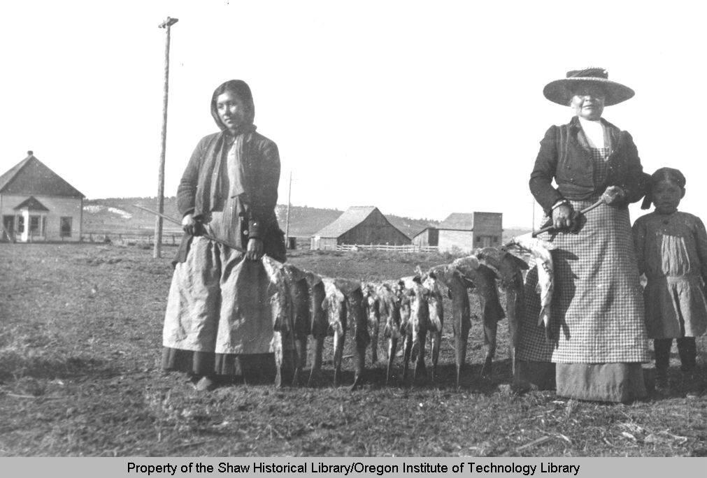Indian women with string of sucker fish