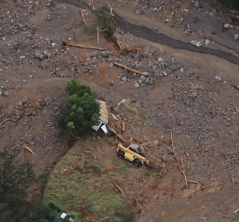 Fully destroyed trailer/home being excavated from mud