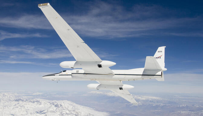 Image shows the NASA AVIRIS aircraft in the air with clouds in the background