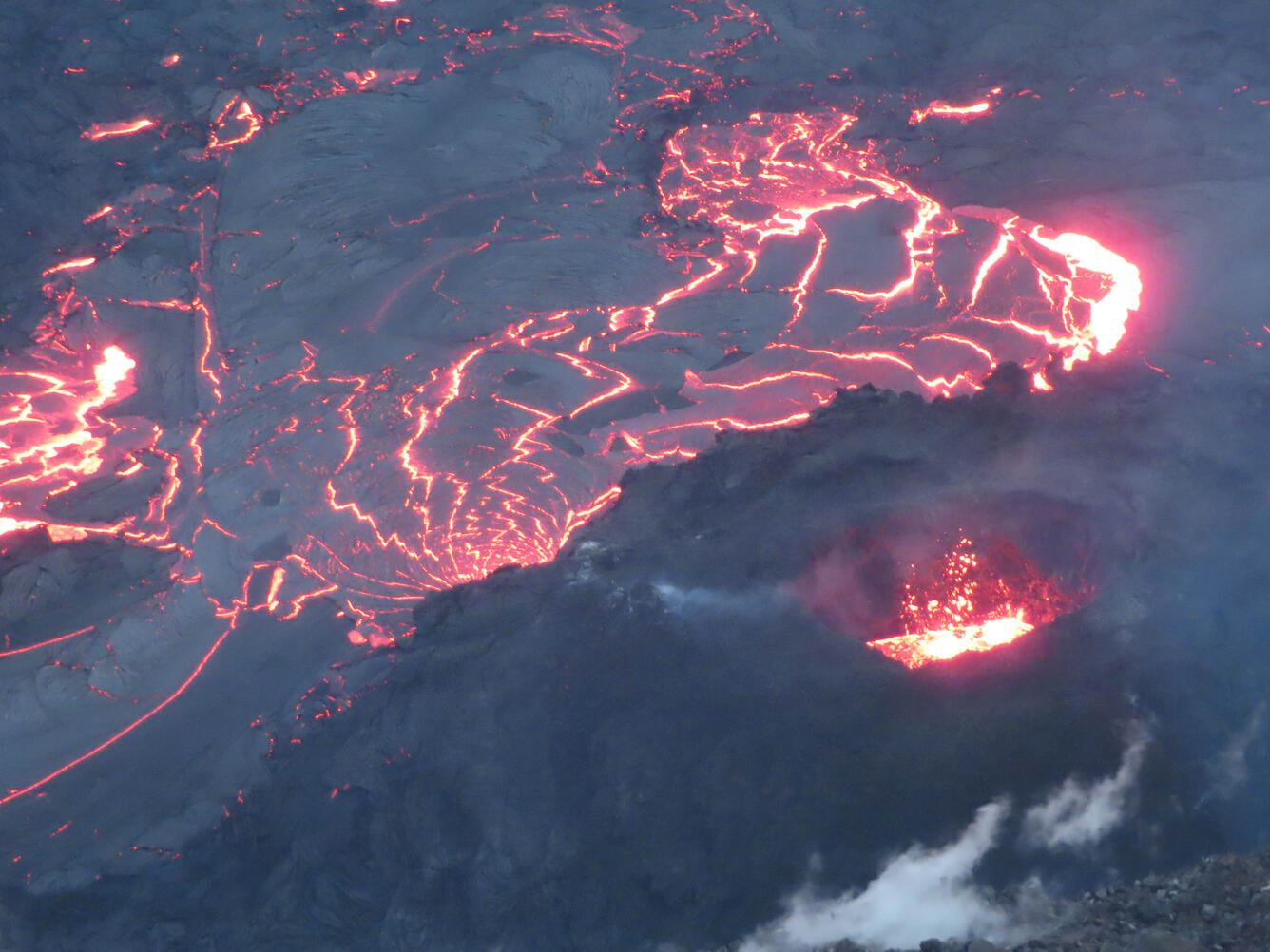 color photograph of lava lake and volcanic vent