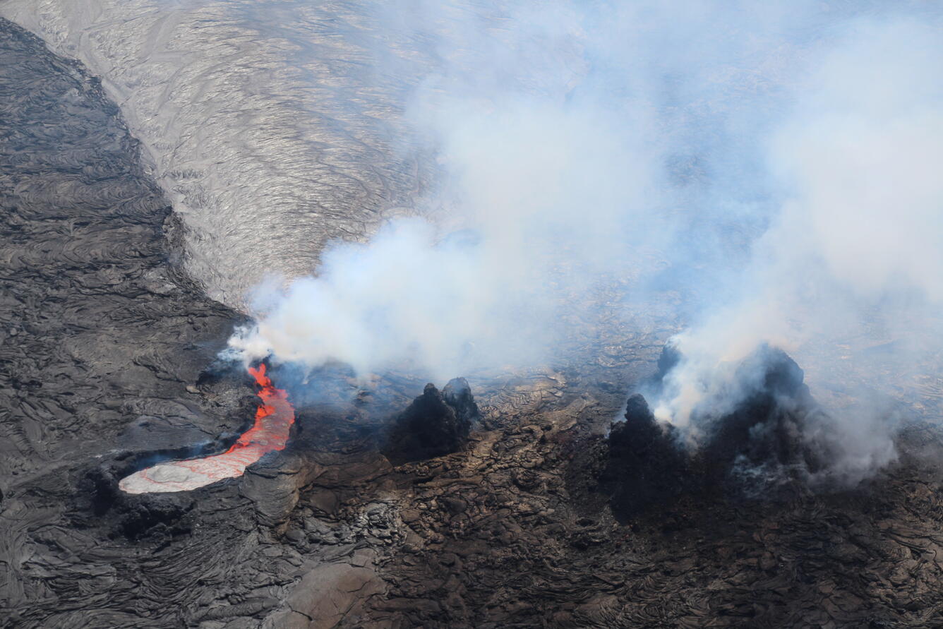 Telephoto view of an active lava lake with thick volcanic gas emissions