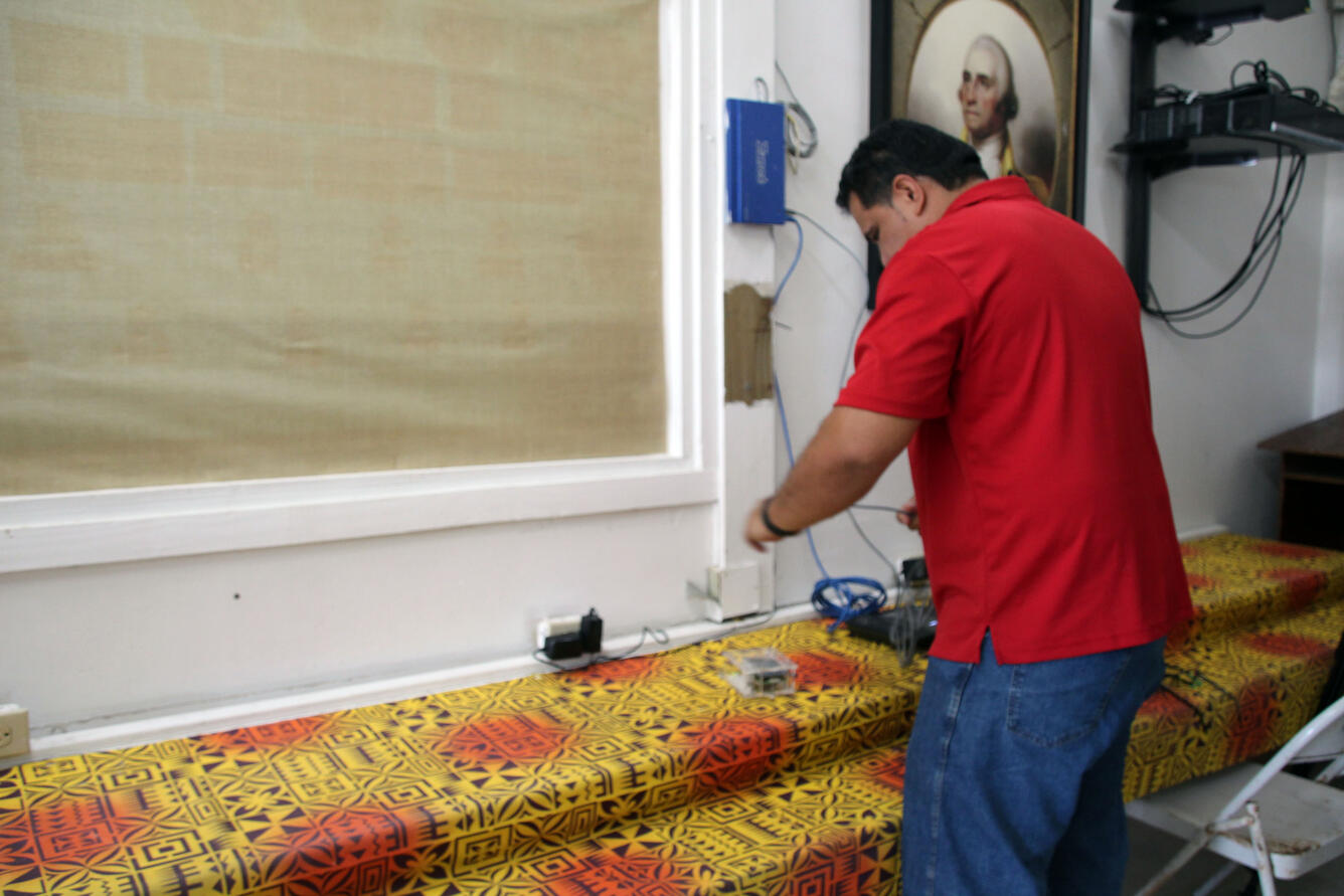 color photograph of scientist installing instrument