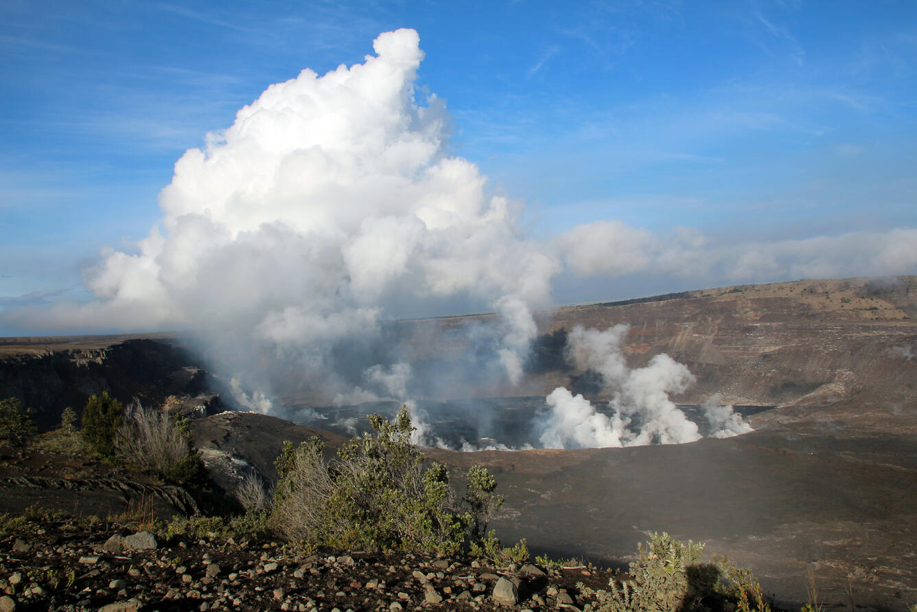 Color photograph of crater erupting