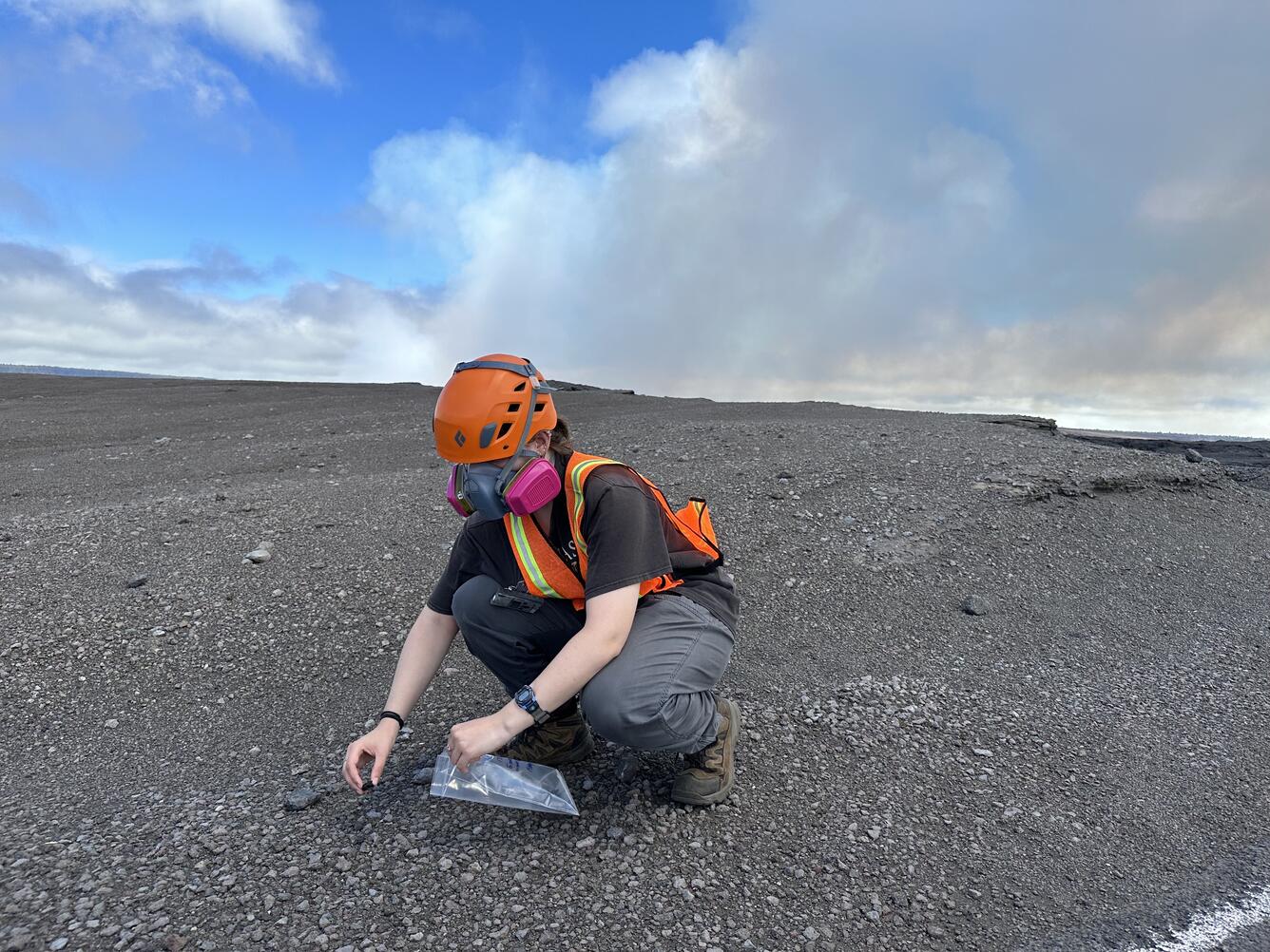 Color photograph of scientist collecting sample