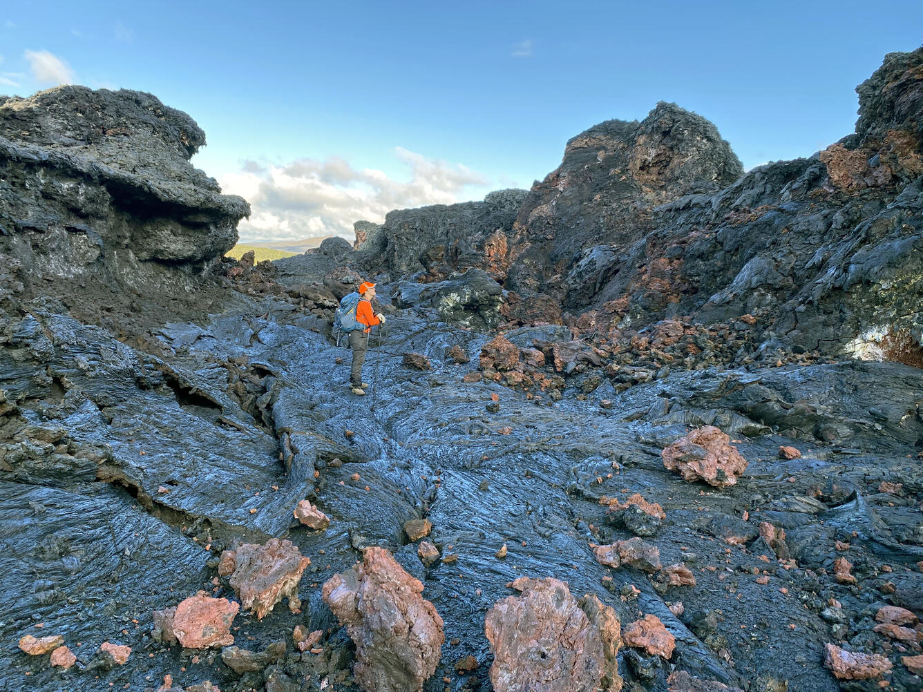 Color photograph of scientist standing in inactive lava channel