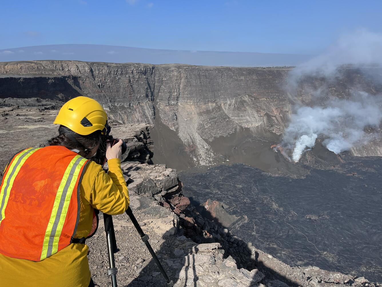 Color photograph of scientist monitoring eruption