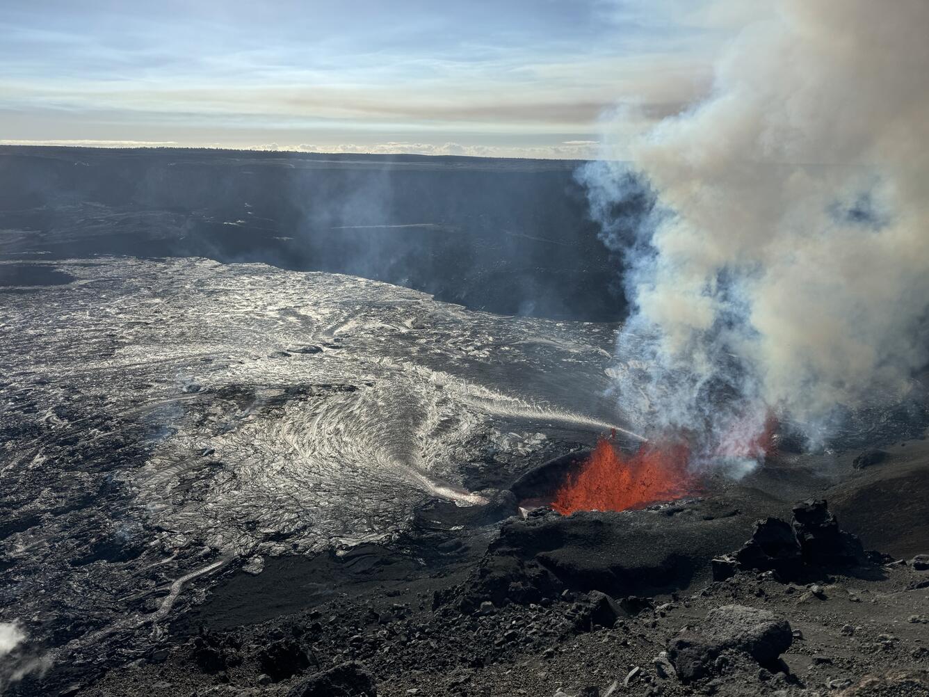 Color photograph of vents erupting lava