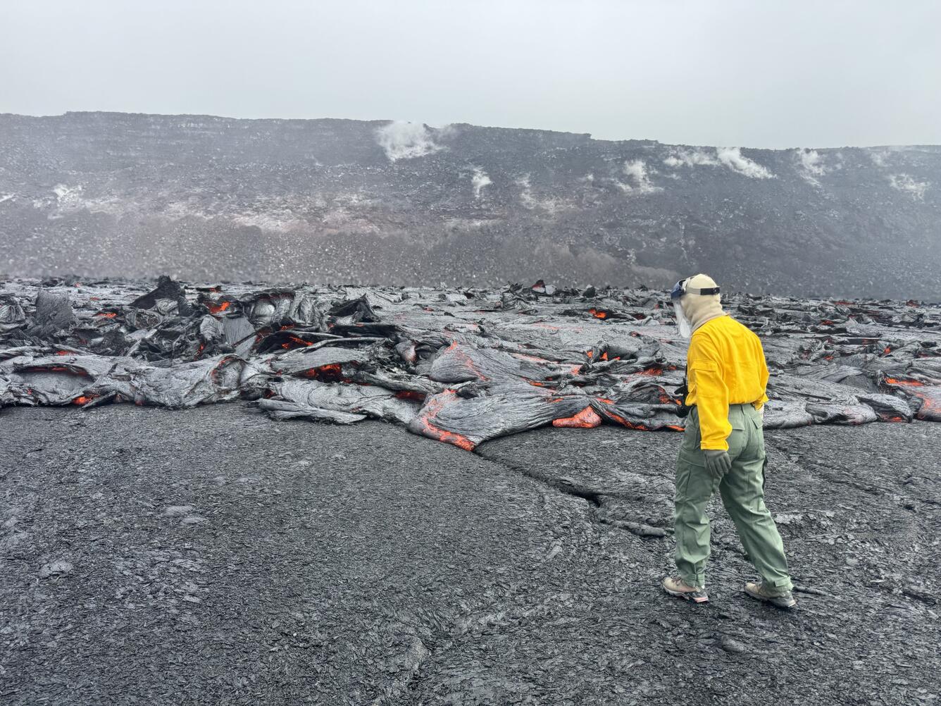 Geologist approaching an active lava flow