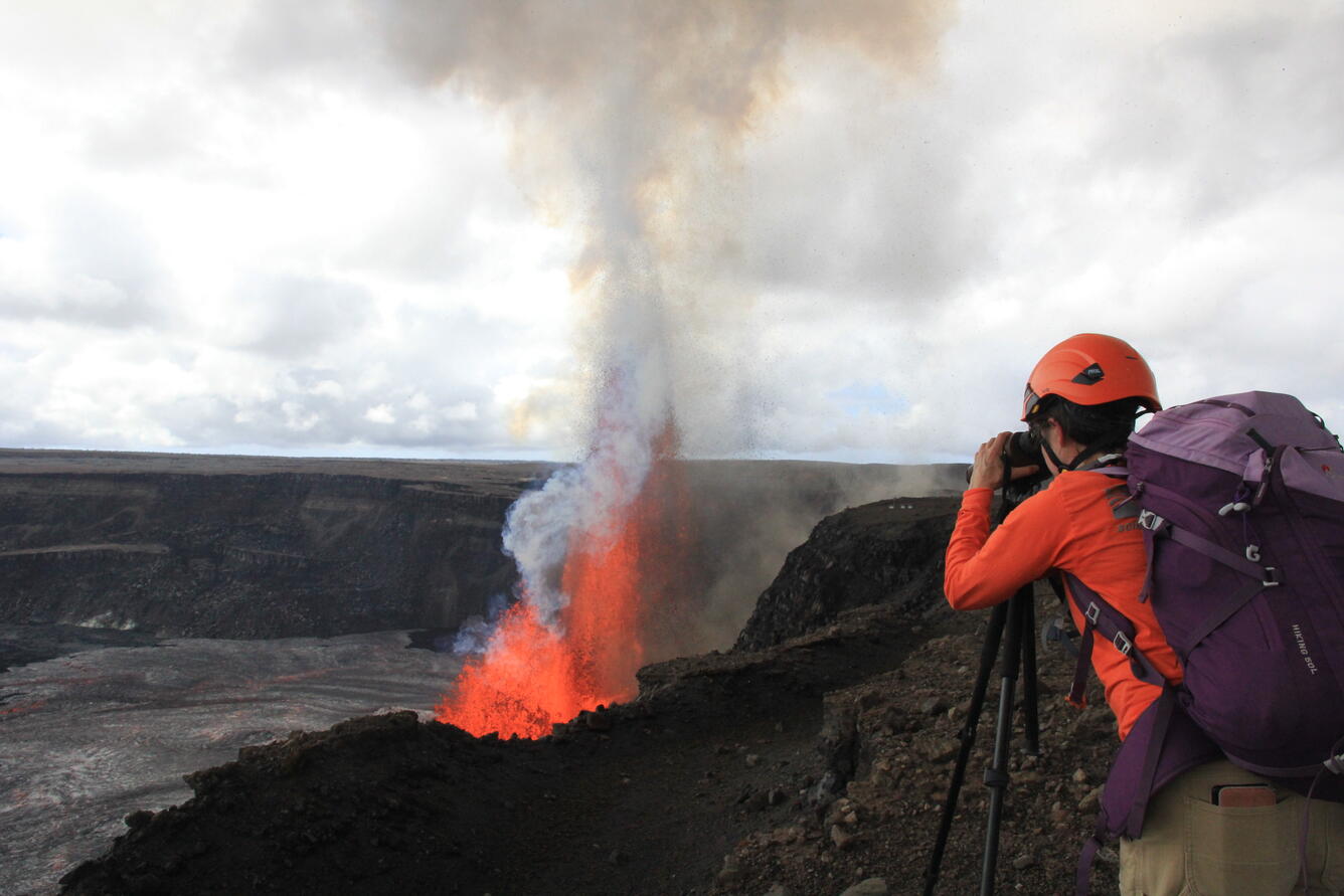 Color photograph of scientist monitoring eruption