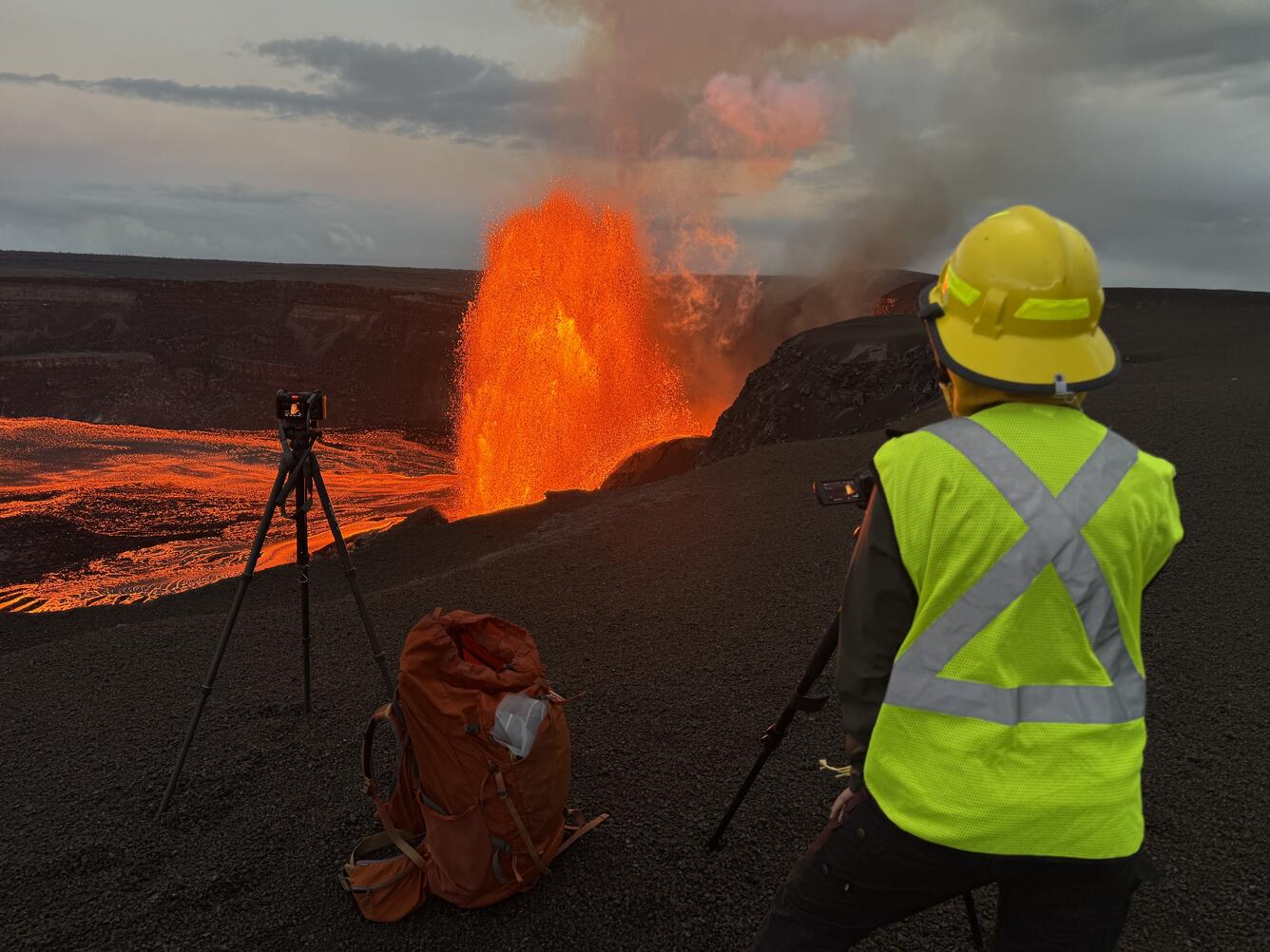 Color photograph of scientist monitoring eruption