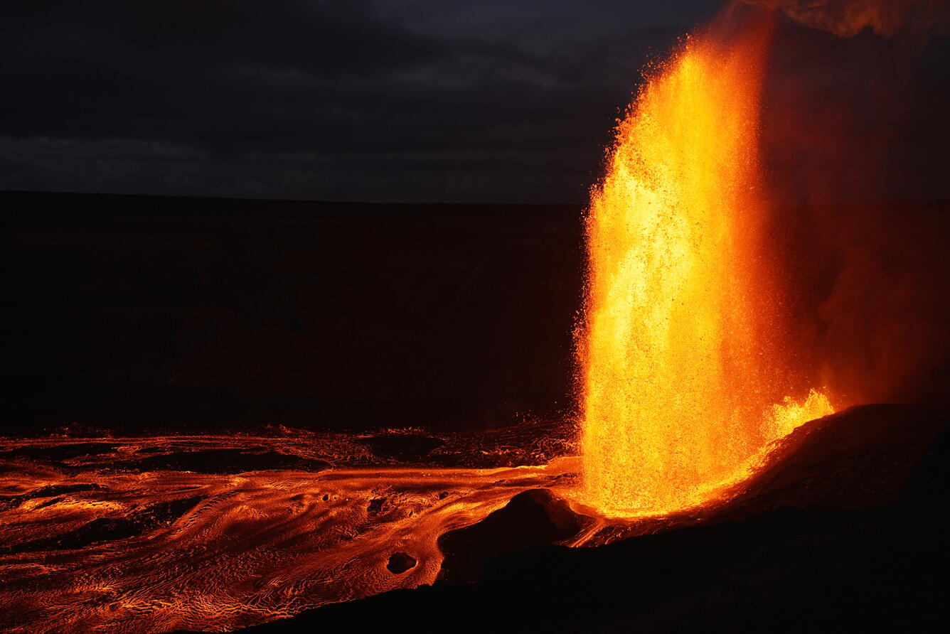 Color photograph of a lava fountain at night