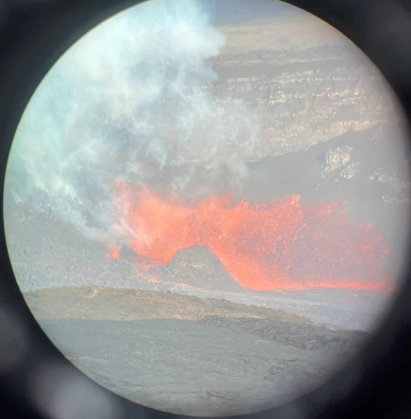 Color photograph of eruption through a lens