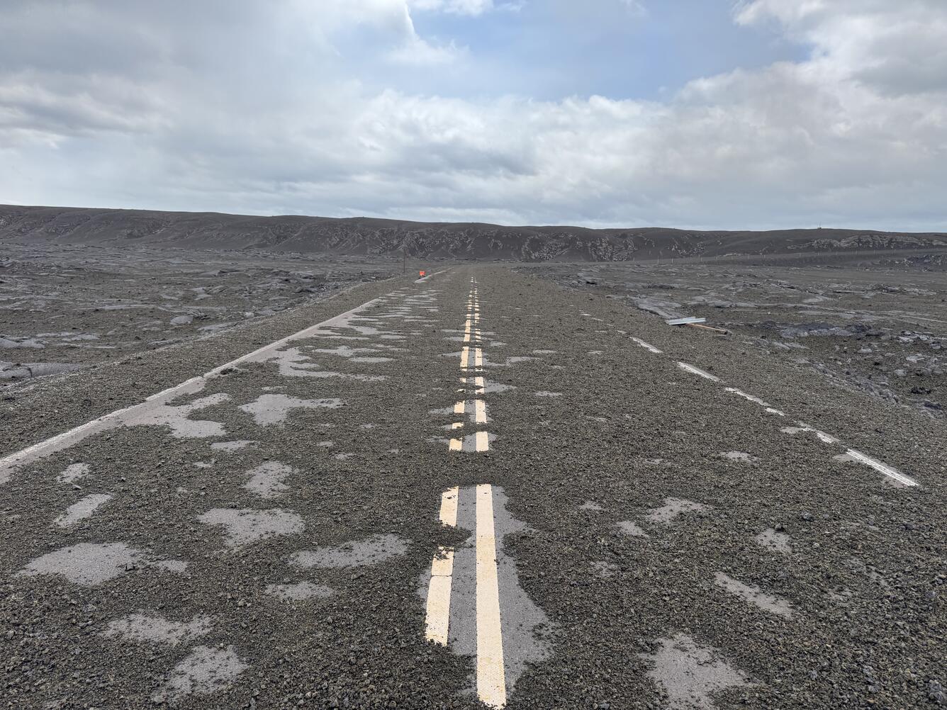 Color photograph of road covered with tephra